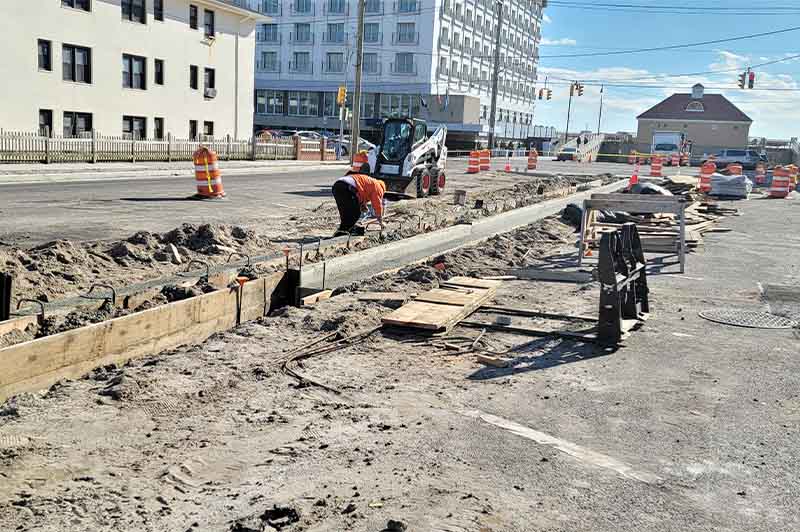 Concrete gutter installation on NYC commercial street for drainage control