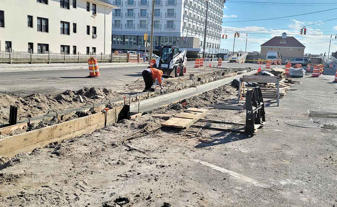 Installing concrete curbs and gutters on National Boulevard